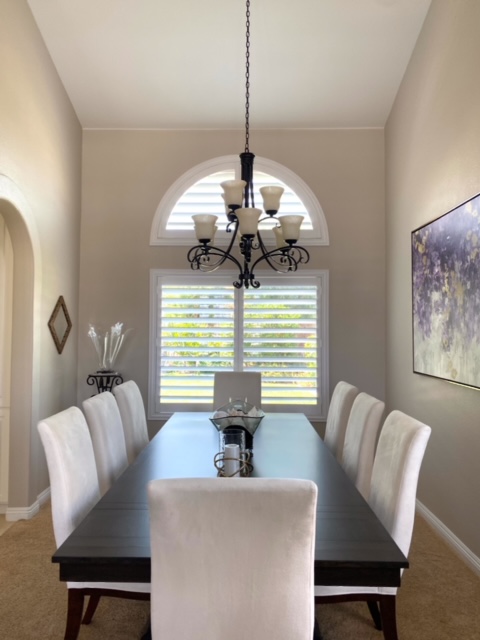 Shutters in dining room with arched window